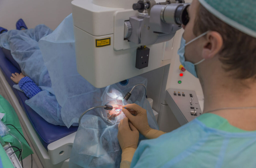 A male eye surgeon is doing cataract surgery. The patient is awake during the surgery, but will not see what the surgeon is doing.